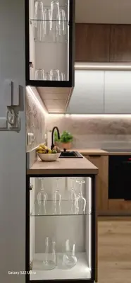 a kitchen with wine glasses on a shelf at Magic House Apartament Proszowska 58 II in Bochnia