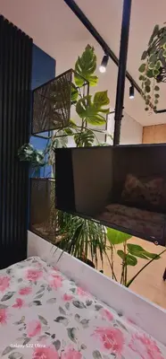 a bedroom with a bed and a plant at Magic House Apartament Proszowska 58 II in Bochnia