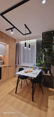 a dining room with a table and two chairs at Magic House Apartament Proszowska 58 II in Bochnia