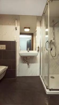 a bathroom with a sink and a shower at Jana Apartments in Kraków