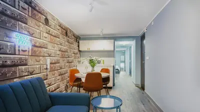 a dining room with a table and orange chairs at Jana Apartments in Kraków