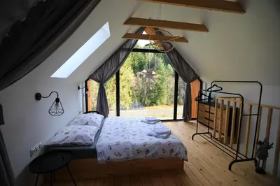 a dining room with a table and a fireplace at Gwiazda Mogielicy basen & balia, sauna in Słopnice