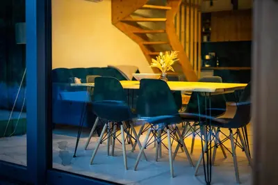 a living room with a couch in front of a house at Gwiazda Mogielicy basen & balia, sauna in Słopnice