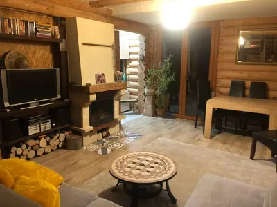 a living room with a fireplace and a television at Ranczo Borówka in Łapanów