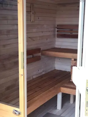 a sauna with wooden benches in a room at Ranczo Borówka in Łapanów