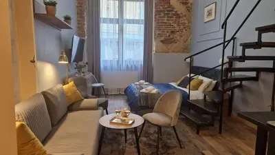 a living room with a couch and a table at Amazing Cracow Apartments in Kraków
