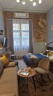 a living room with a bed and a couch at Amazing Cracow Apartments in Kraków