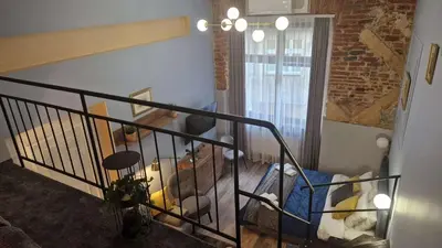 a room with a staircase with a stair railing at Amazing Cracow Apartments in Kraków