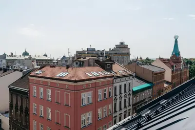 an aerial view of a city with a red building at Muse by StayLab in Kraków