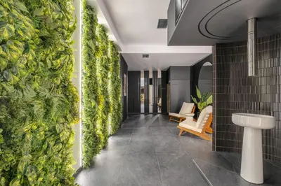 a hallway with a green wall in a building at Muse by StayLab in Kraków