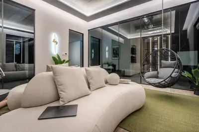 a living room with a couch and a chair at Muse by StayLab in Kraków