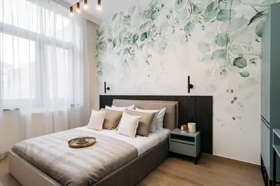 a bedroom with a bed with a flower mural on the wall at Muse by StayLab in Kraków