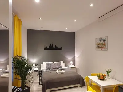 a bedroom with a bed and a desk and a table at L-2 Kraków Center Studio O&P ApartFamily in Kraków