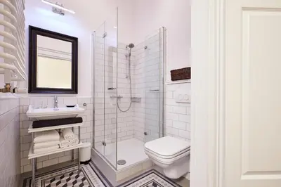a bathroom with a shower toilet and a sink at Piasek Elegant Apartments in Kraków
