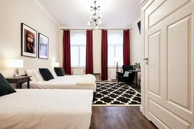 a hotel room with two beds and a window at Piasek Elegant Apartments in Kraków