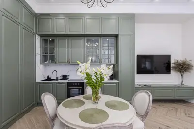a kitchen with a table with a vase of flowers on it at Apartament w Centrum Krakowa 106 in Kraków