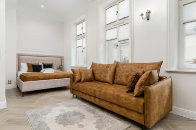 a living room with a couch and a bed at Apartament w Centrum Krakowa 106 in Kraków