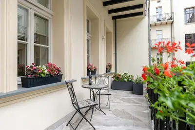 a patio with chairs and flowers on a building at Apartament w Centrum Krakowa 106 in Kraków