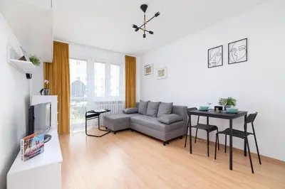 a living room with a couch and a table at Comfy & Bright Studio Wielicka in Krakow by Noclegi Renters in Kraków