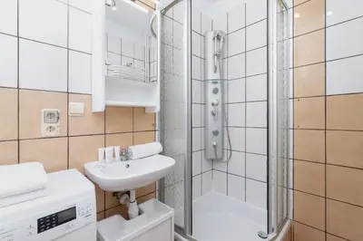 a white bathroom with a shower and a sink at Comfy & Bright Studio Wielicka in Krakow by Noclegi Renters in Kraków