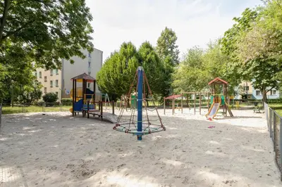 a playground in a park with a swing set at Comfy & Bright Studio Wielicka in Krakow by Noclegi Renters in Kraków