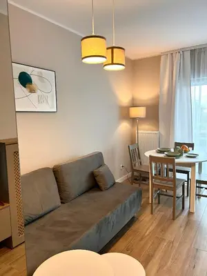 a living room with a couch and a table at Apartament Novo 46 in Kraków