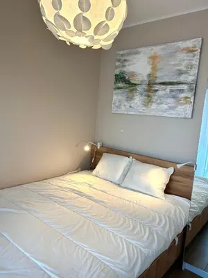 a bed in a bedroom with a chandelier at Apartament Novo 46 in Kraków
