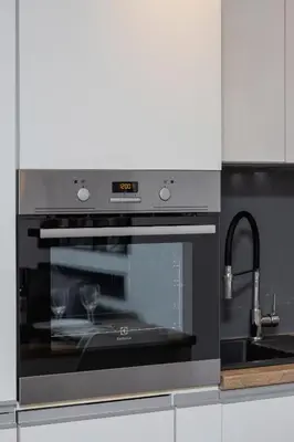 a kitchen with an oven and a sink at Zabłocie Pet-friendly Ślusarska Apartment by Noclegi Renters in Kraków