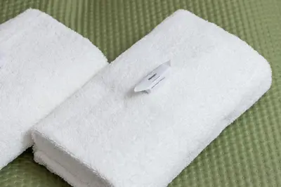 a white towel with a sticker on top of it at Zabłocie Pet-friendly Ślusarska Apartment by Noclegi Renters in Kraków