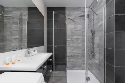 a bathroom with a sink and a shower at Zabłocie Pet-friendly Ślusarska Apartment by Noclegi Renters in Kraków