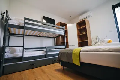 a bedroom with two bunk beds and a television at Noclegi u Szymonków Zator Przeciszów in Zator