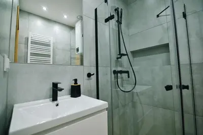 a bathroom with a shower and a sink and a glass shower stall at Noclegi u Szymonków Zator Przeciszów in Zator