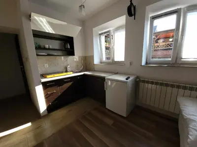 a small kitchen with a sink and a refrigerator at Apartamenty Kącik in Kraków