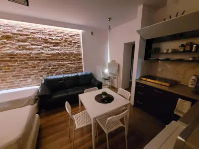 a living room with a couch and a table at Apartamenty Kącik in Kraków