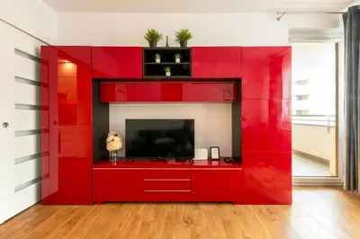 a red entertainment center with a flat screen tv at Apartment BLUE PEARL 2 rooms Down Town 4 persons balcony free parking in Kraków