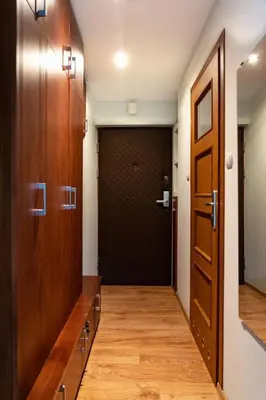 a hallway with two elevators and a door at Studio Asnyka Old Town in Kraków