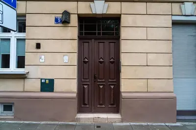 a brown door on the side of a building at Studio Asnyka Old Town in Kraków