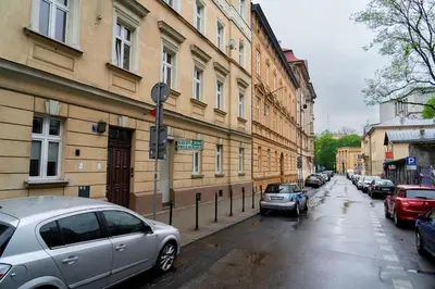 a street with cars parked on the side of a building at Studio Asnyka Old Town in Kraków