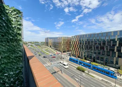 a view of a city street with a train at Stylowe studio z parkingiem - 3 minuty od Dworca & Galerii Krakowskiej in Kraków