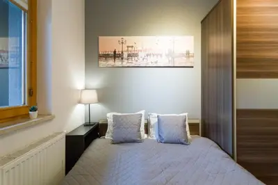 a bedroom with a bed with blue pillows at Romanowicza 5 Serene Place in Kraków