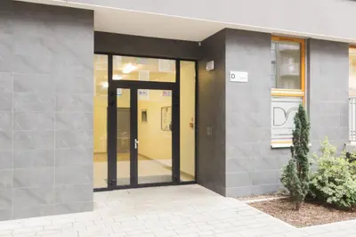 an entrance to a building with glass doors at Romanowicza 5 Serene Place in Kraków