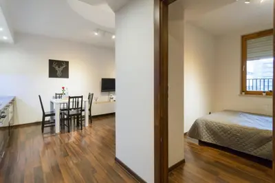 a room with a bed and a table with chairs at Romanowicza 5 Serene Place in Kraków