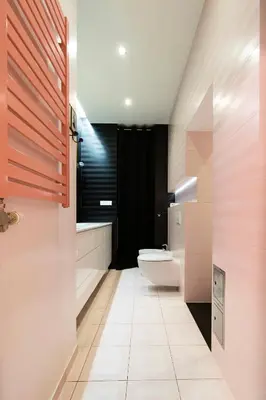 a bathroom with a toilet and a black wall at Spacious 3BR apartment with AC in living room, 2 balconies in Kraków