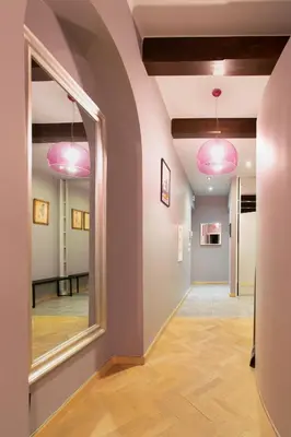 a hallway with pink lights and a mirror at Spacious 3BR apartment with AC in living room, 2 balconies in Kraków