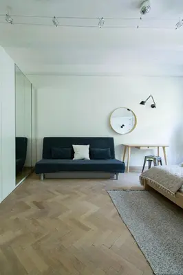 a living room with a blue couch and a table at Spacious 3BR apartment with AC in living room, 2 balconies in Kraków