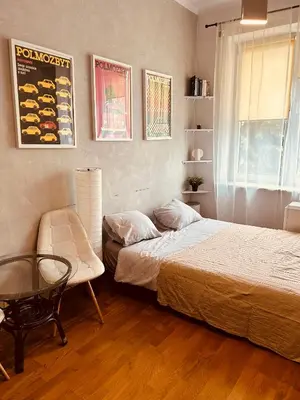 a bedroom with two beds and a table and a chair at KR Apartament in Kraków