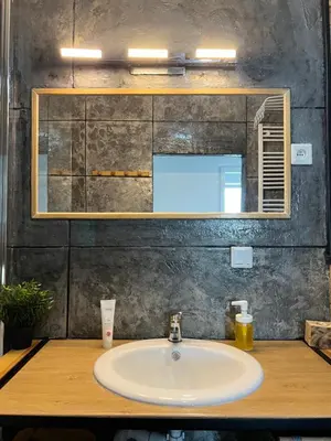 a bathroom with a sink and a mirror at Cracovia Apartment in Kraków