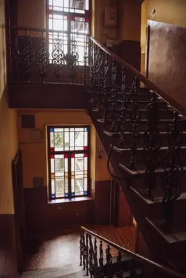 a spiral staircase in a building with windows at Kraków Wawel Zwierzyniecka in Kraków