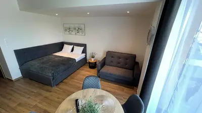 a bedroom with a bed and a chair and a table at Rising Sun 3 by Housine,pl in Zator