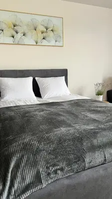 a bed with a black comforter and white pillows at Rising Sun 3 by Housine,pl in Zator